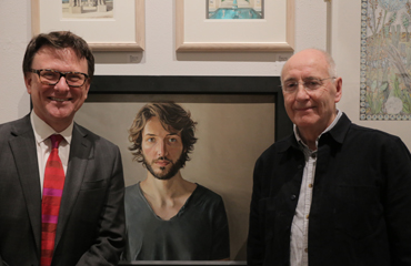 Thumbnail image of Chris Hailes of Charles Stanley with Geoffrey Beasley in front of 'Portrait of Alex' - LSA Annual Exhibition 2017 Prize Winners